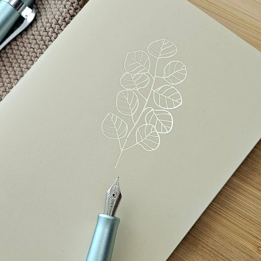 Artchemira a6 pocket journal in warm sand tone with gold foil eucalyptus design on cover