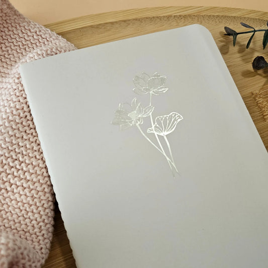 Artchemira large journal in dusty rose with gold foil lotus design cover, on bamboo