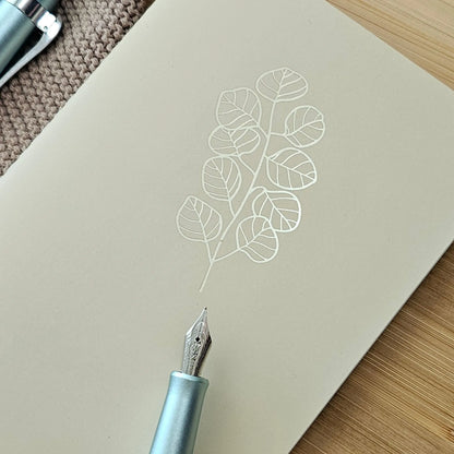Artchemira a6 pocket  journal in warm sand tone with gold foil eucalyptus design on cover 