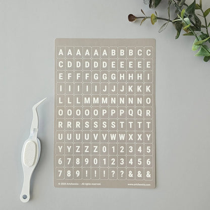 Artchemira cappuccino-toned alphabet sticker sheet with white crafting tweezer tool
