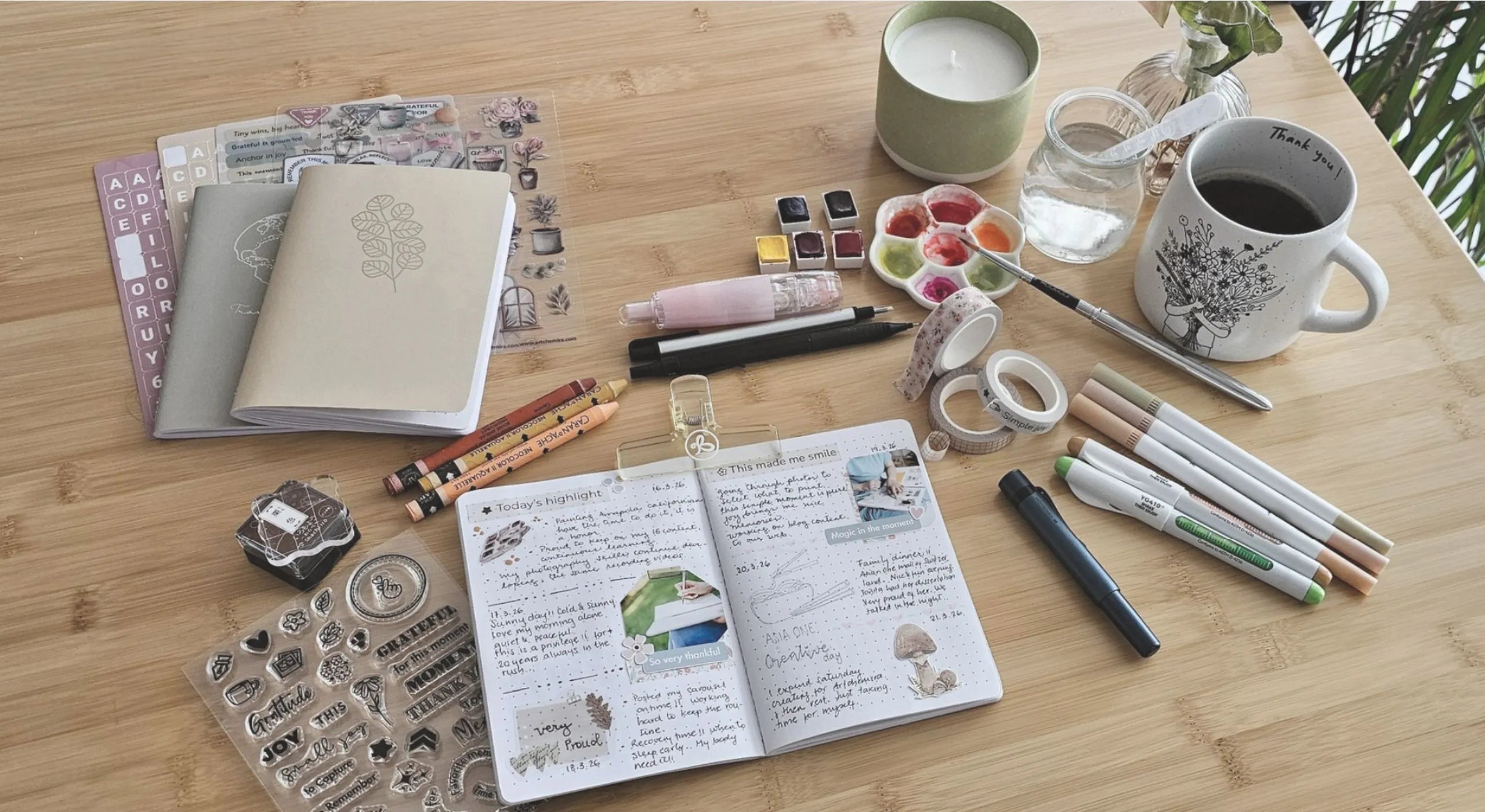 Artistic workspace with open journal, pens, markers, and coffee cup on wooden table — symbolizing creativity, reflection, and mindful productivity