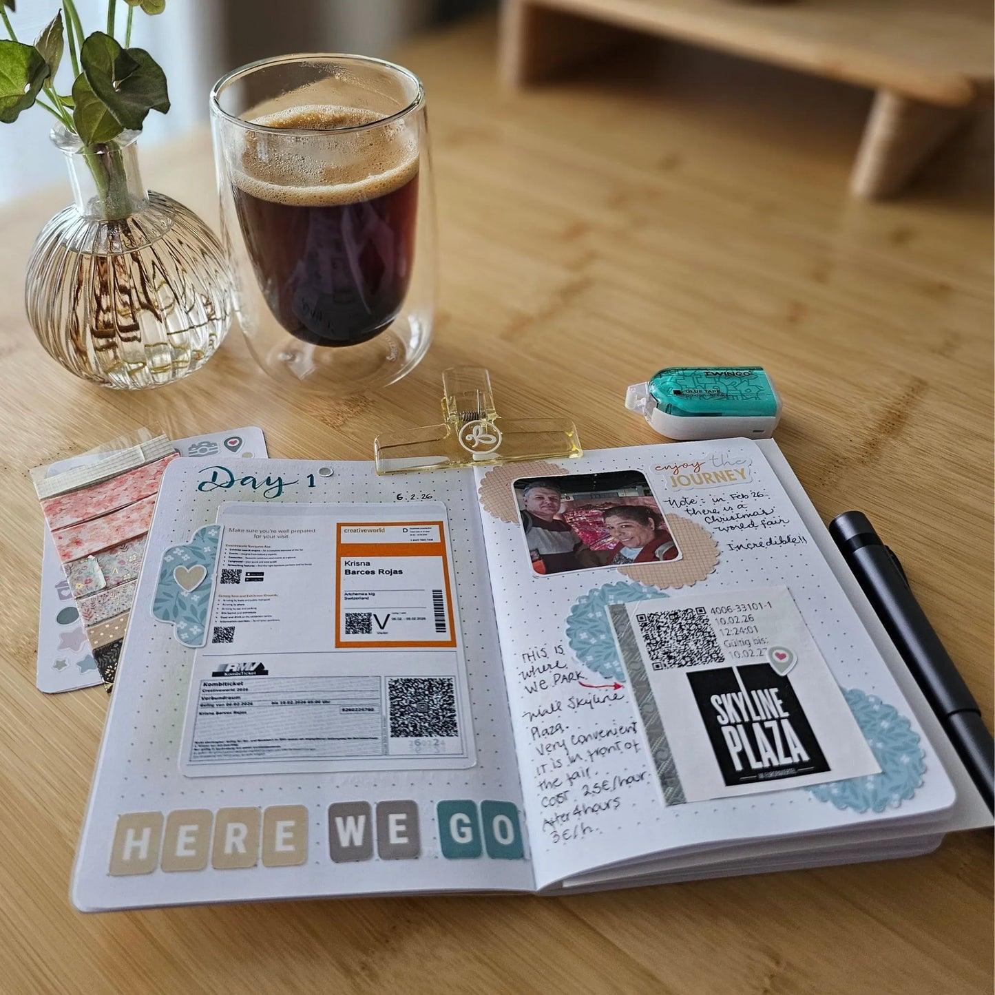 Artchemira open travel journal spread with maps, photos, and notes beside a cup of coffee