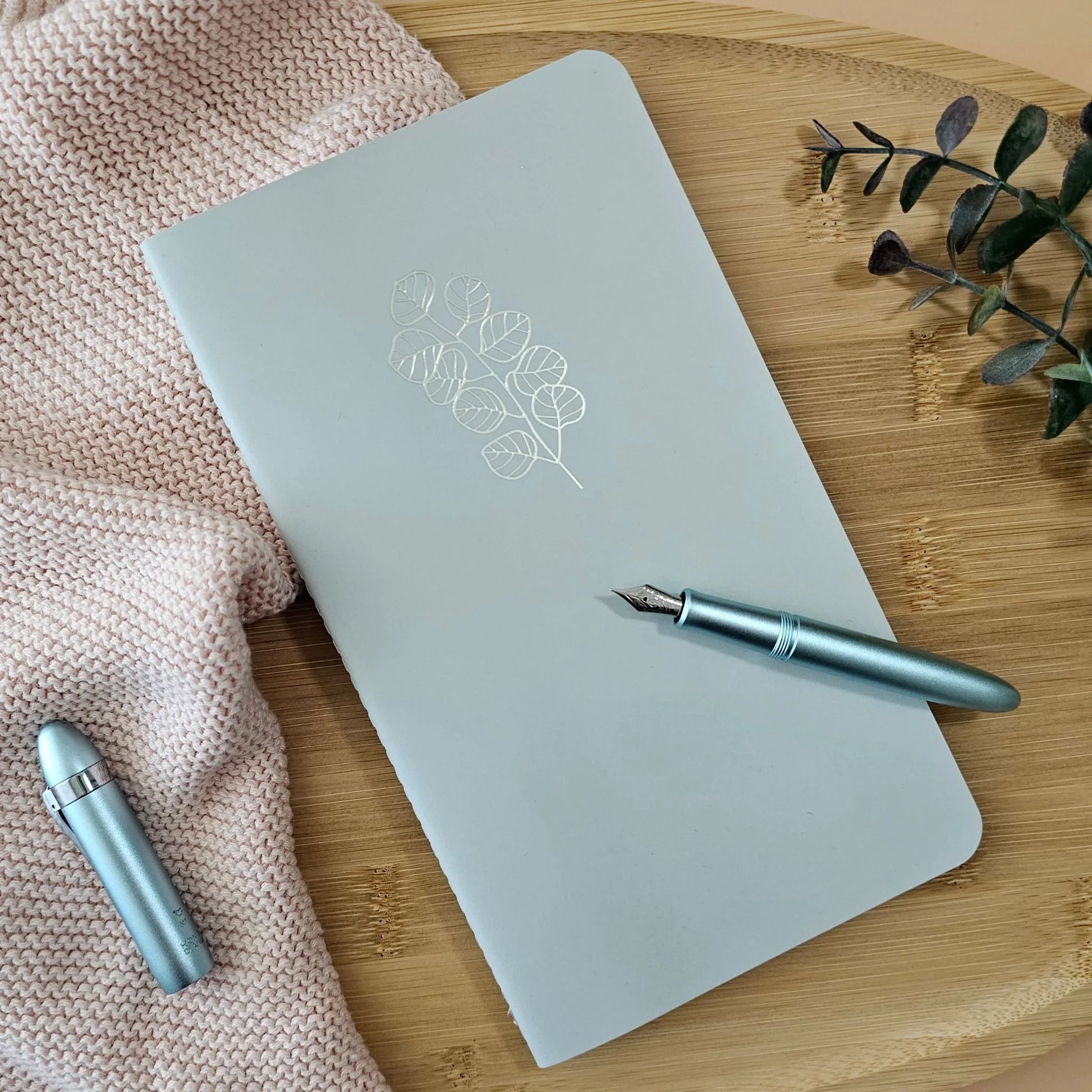 Artchemira large sage journal with champagne gold foil botanical cover, blue pen on bamboo
