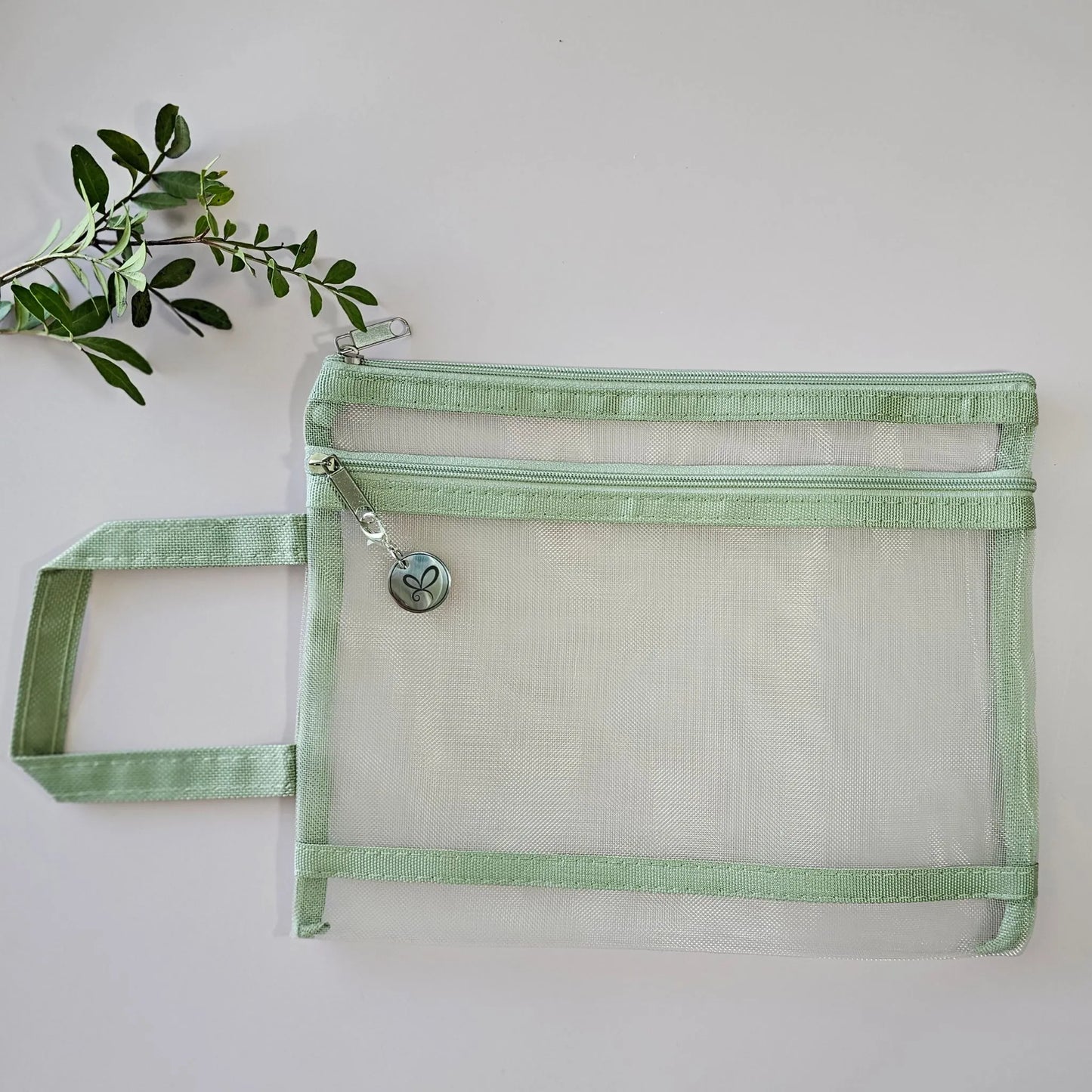 Artchemira A5 sage green nylon mesh journaling bag with double zipper, flat lay styled view